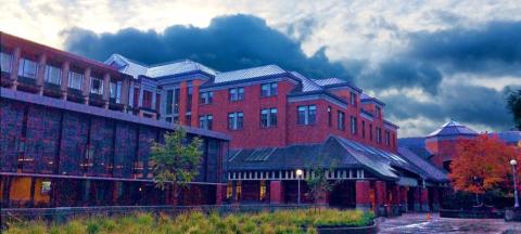 Red brick exterior of Willamette Hall on an overcast day.