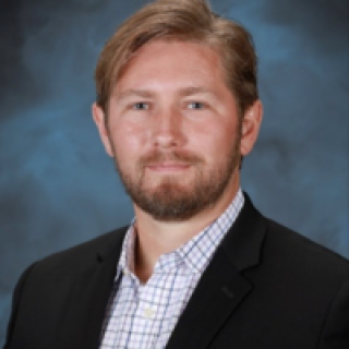 Headshot of Travis Humble.