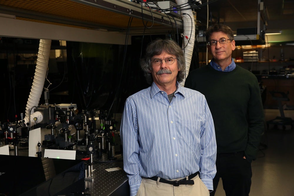 Michael Raymer (left) and Andy Marcus in their lab.